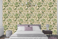 Faux embroidered chinoiserie wallpaper featuring green songbirds perched on curving branches, satin-stitch peony roses, chain-stitch trailing vines, teal berry clusters, and a hidden lizard in a tonal green palette on warm cream silk-textured ground — premium heritage craft wallpaper by WallpaperPixi