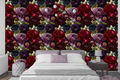 Dark gothic rose and anemone wallpaper styled as a dramatic bedroom feature wall with deep velvet headboard, brass candlelight, and jewel-toned accessories — peel and stick or traditional paste moody floral wallpaper by WallpaperPixi