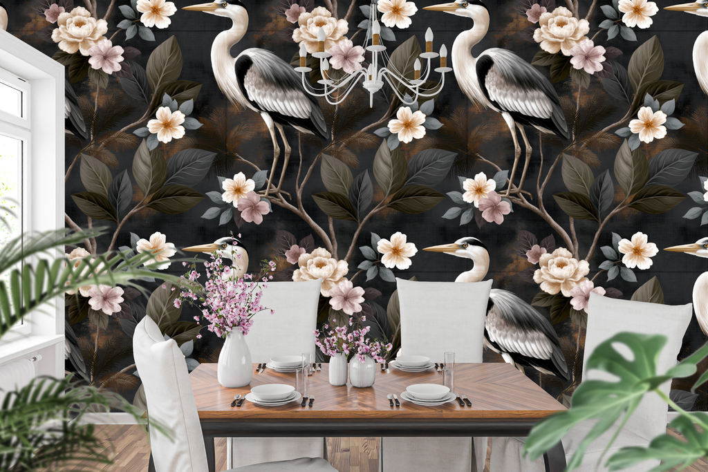 Dark chinoiserie wallpaper featuring white herons with detailed plumage, ivory and blush camellia blossoms, gnarled dark branches, and olive bronze foliage on a richly textured charcoal ground with copper-gold accents — premium moody heritage wallpaper by WallpaperPixi