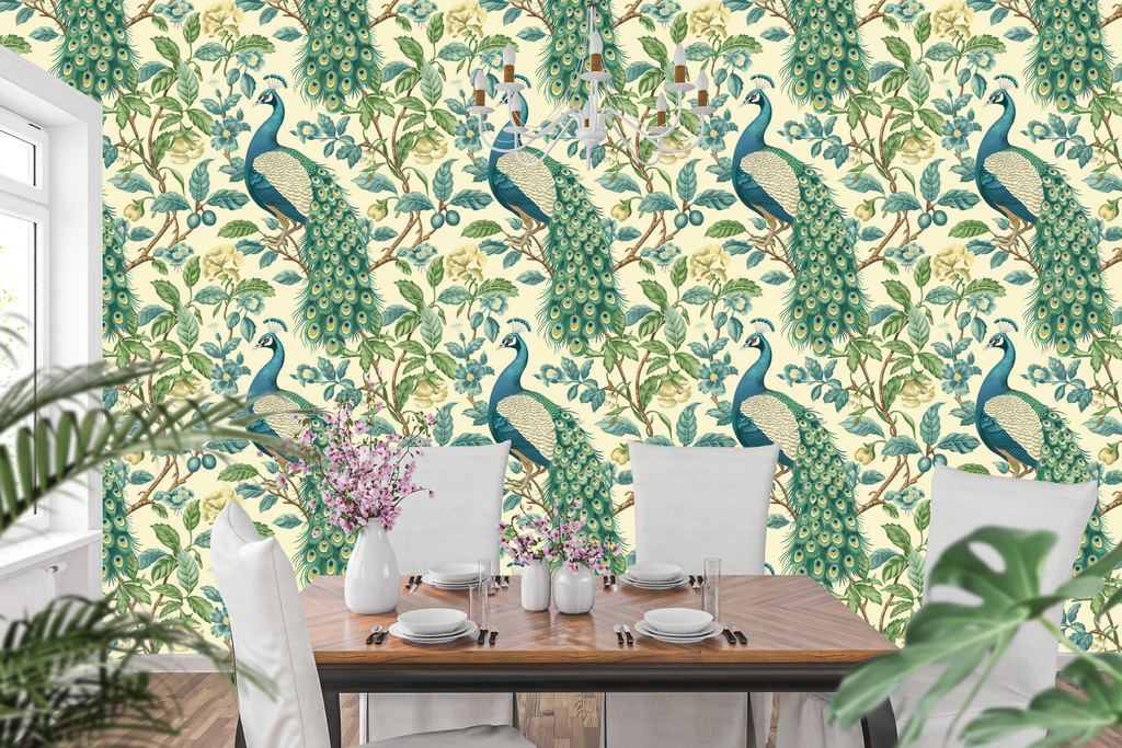 Chinoiserie peacock wallpaper featuring magnificent peacock birds with detailed emerald and sapphire plumage, cascading golden-eyed tail feathers, blue and ivory botanical blossoms, trailing branches, and rich green foliage on a warm ivory ground — premium heritage bird wallpaper by WallpaperPixi