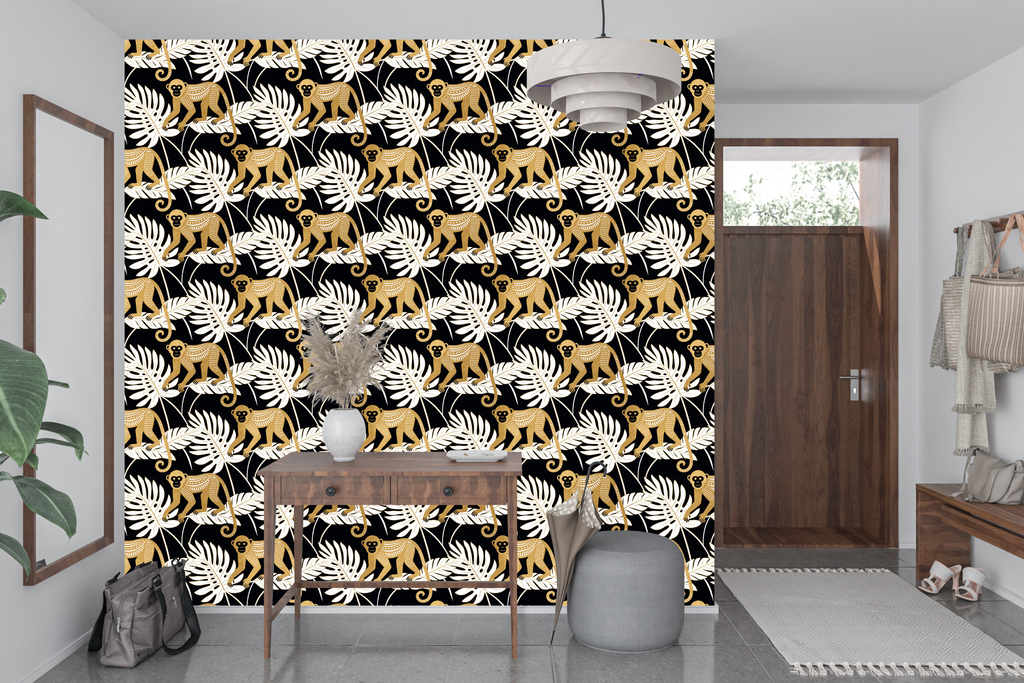 Black and gold jungle monkey wallpaper styled as a dramatic living room or home bar feature wall with brass lighting, black leather furniture, and warm amber accents — peel and stick or traditional paste tropical wallpaper by WallpaperPixi