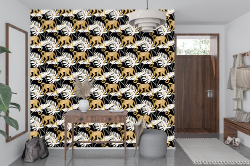 Black and gold jungle monkey wallpaper styled as a dramatic living room or home bar feature wall with brass lighting, black leather furniture, and warm amber accents — peel and stick or traditional paste tropical wallpaper by WallpaperPixi