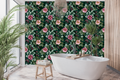 Dark teal vintage wallpaper featuring painterly pink and blush wild rose blooms with golden stamens, magenta rose hip berries, dark blackberry buds, and lush sage and olive serrated leaves on a deep teal ground — premium moody botanical wallpaper by WallpaperPixi