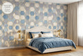Art Deco geometric wallpaper in an elegant sophisticated bedroom with dusty blue gold and cream tones