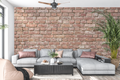 Authentic weathered red brick mural in an industrial loft living room