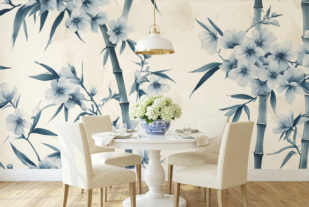 Blue chinoiserie bamboo blossom wallpaper mural in an elegant dining room with a white dining table and blue and white porcelain