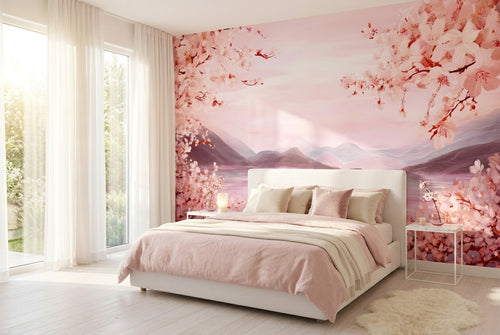 Cherry blossom mountain lake wall mural accent wall in a bright romantic bedroom with white upholstered bed and blush pink bedding