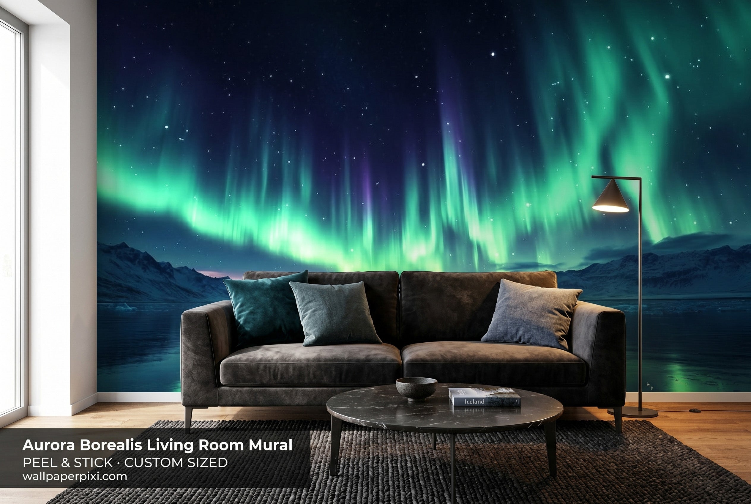 Aurora borealis landscape wall mural in a dramatic living room behind a dark sofa with teal and charcoal accents and atmospheric lighting