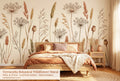 Terracotta botanical dried wildflower wall mural in a bright boho bedroom with a low platform bed warm linen bedding rattan accessories and natural wood furniture.