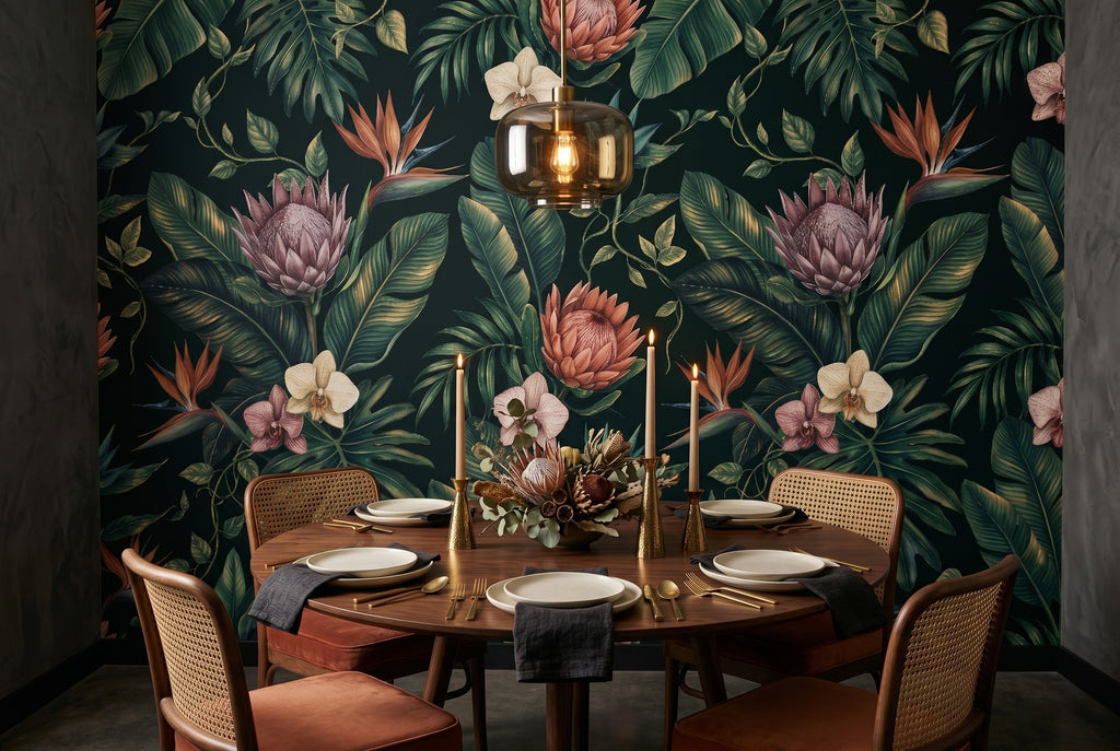 Dark tropical botanical wallpaper mural styled in a luxury bedroom accent wall setting with warm brass lighting, natural linen textiles, and rattan accessories — peel and stick or traditional wallpaper by WallpaperPixi