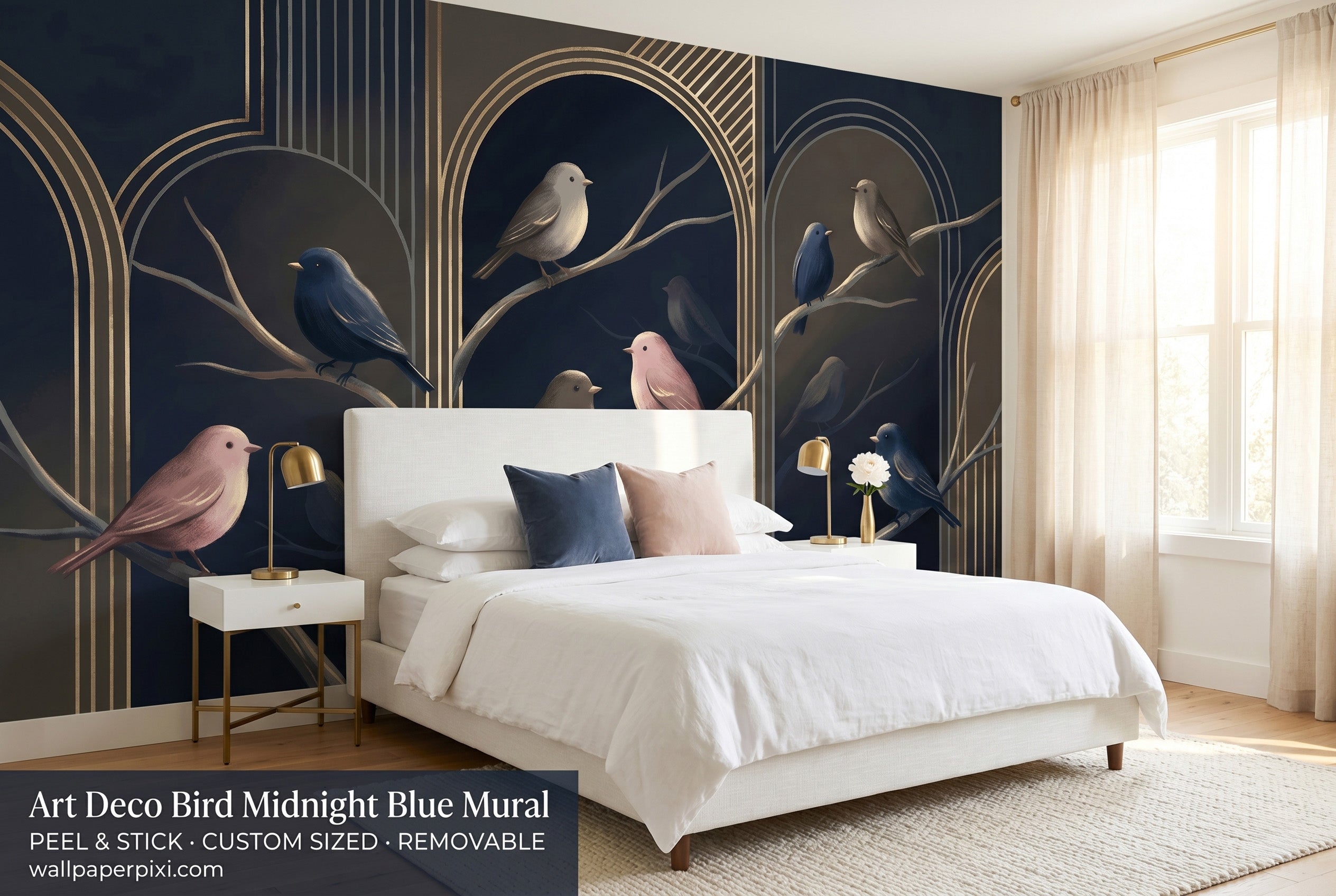 Art deco bird midnight blue wall mural in a bright elegant bedroom behind a white upholstered bed with navy and blush cushions and warm brass lighting