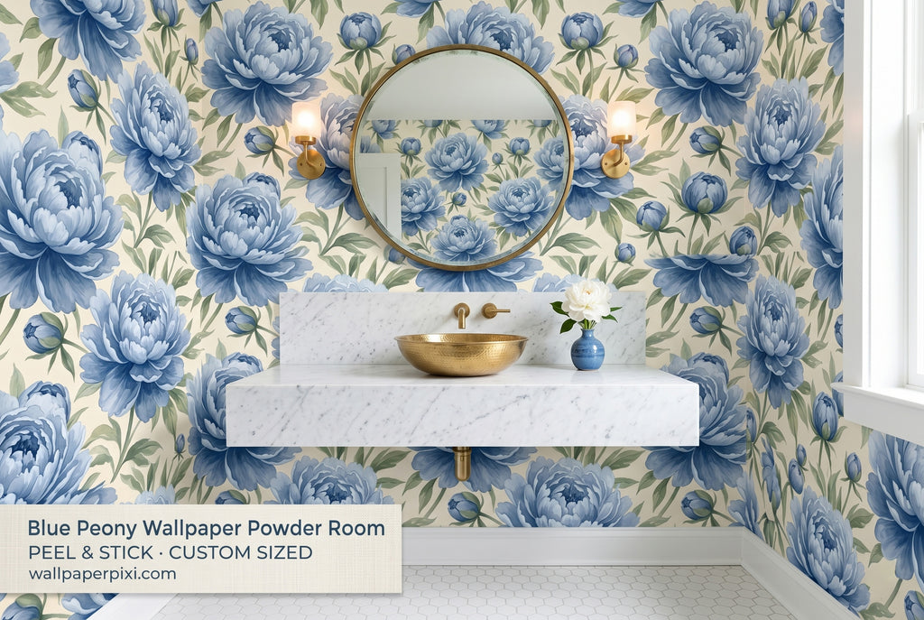Blue peony chinoiserie wallpaper in a bright powder room with a white marble vanity brass fixtures and a round gold mirror