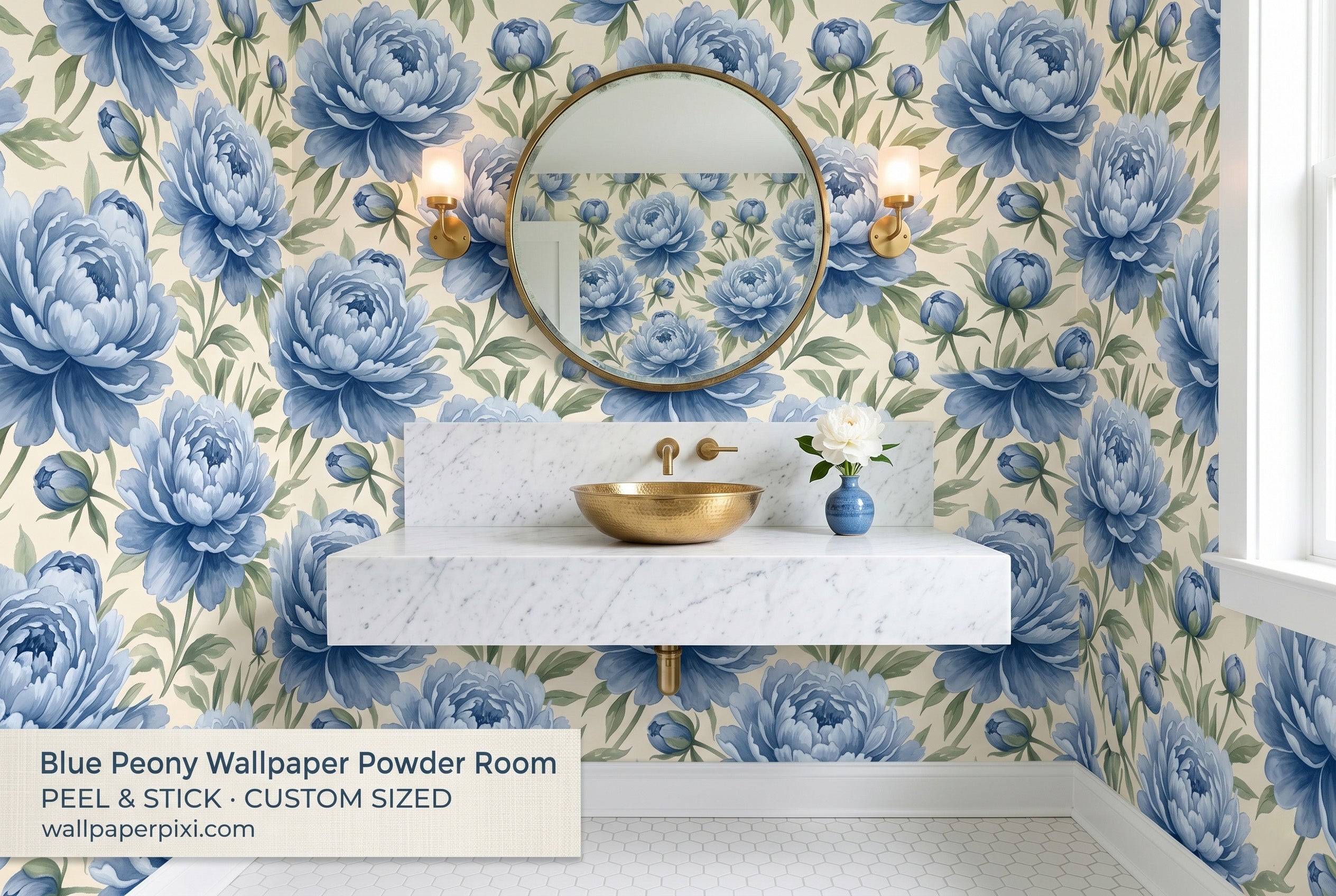 Blue peony chinoiserie wallpaper in a bright powder room with a white marble vanity brass fixtures and a round gold mirror