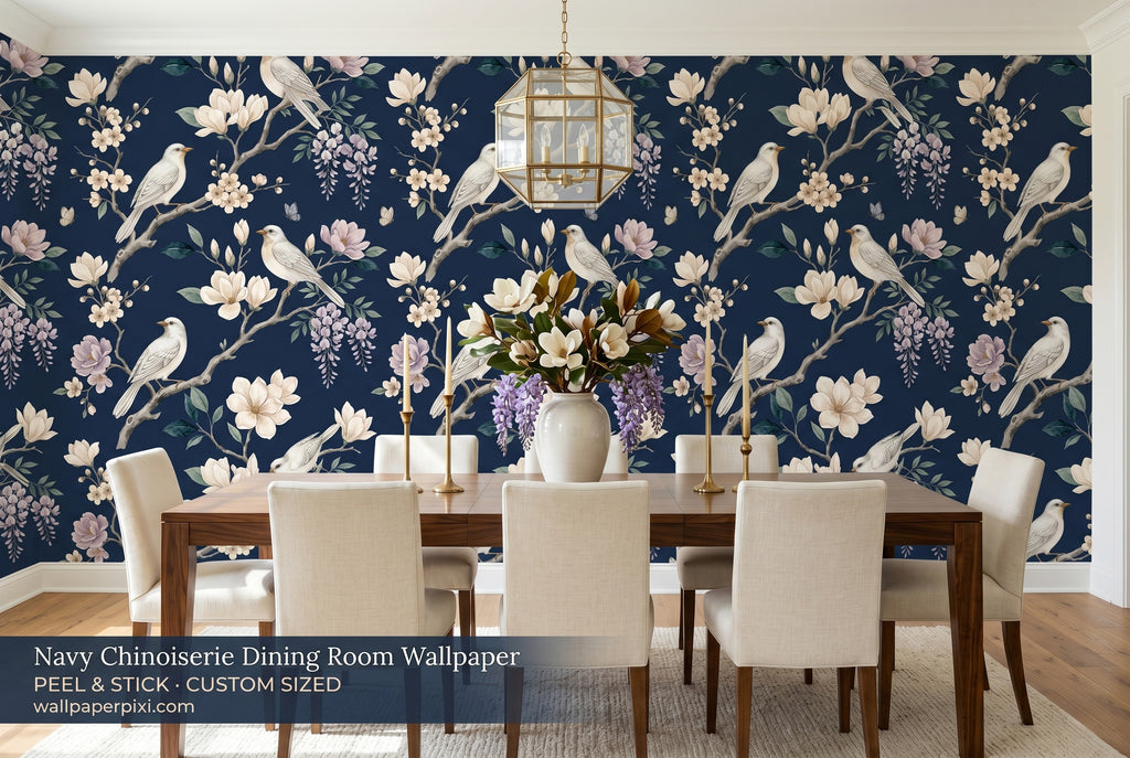 Dark navy chinoiserie bird wallpaper in a bright elegant dining room with a dark walnut table cream linen chairs and brass candleholders