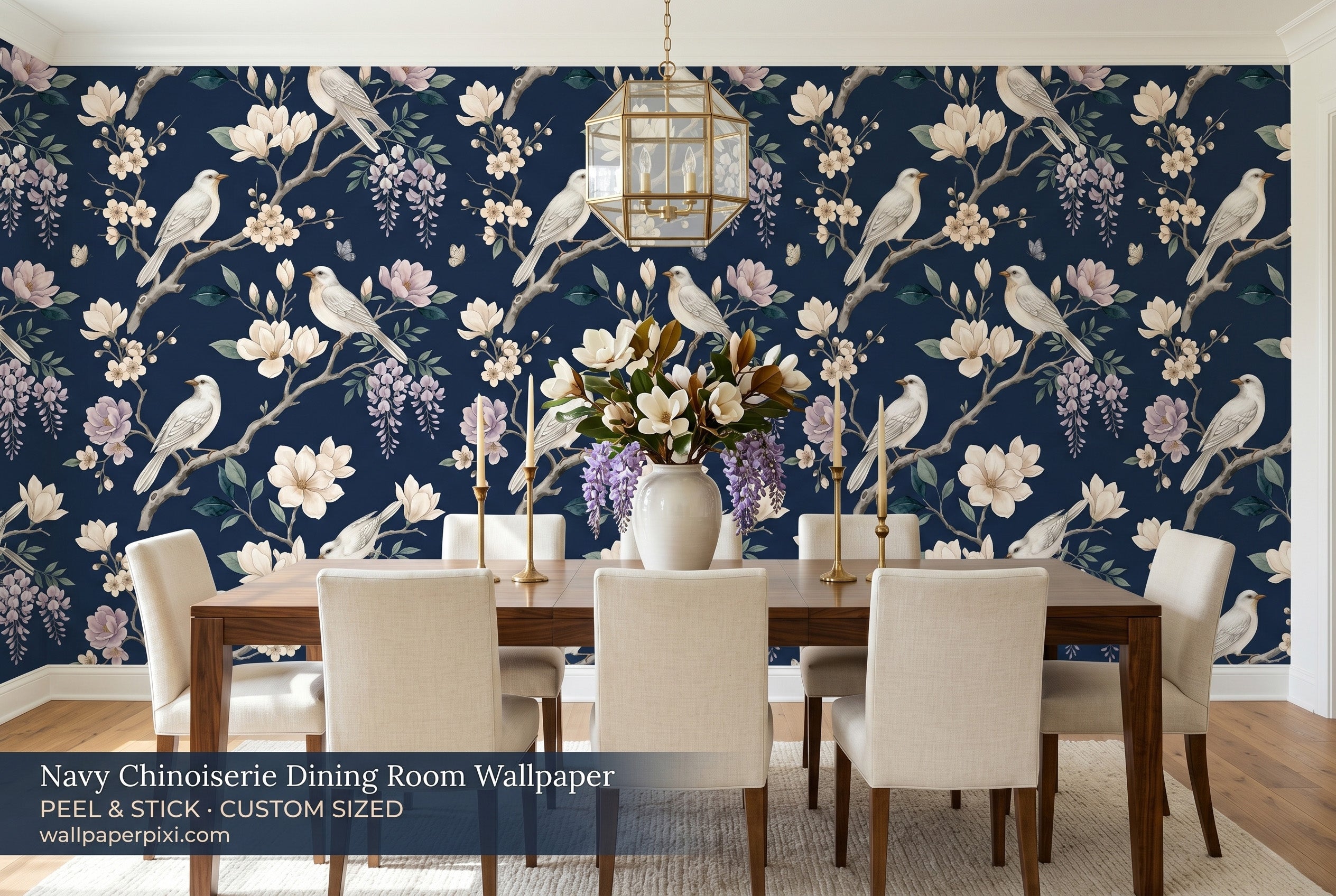 Dark navy chinoiserie bird wallpaper in a bright elegant dining room with a dark walnut table cream linen chairs and brass candleholders
