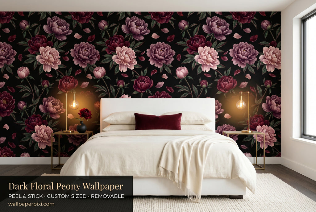 Dark floral black peony wallpaper in a bright dramatic bedroom with a white upholstered bed cream bedding burgundy velvet cushion and warm brass lighting