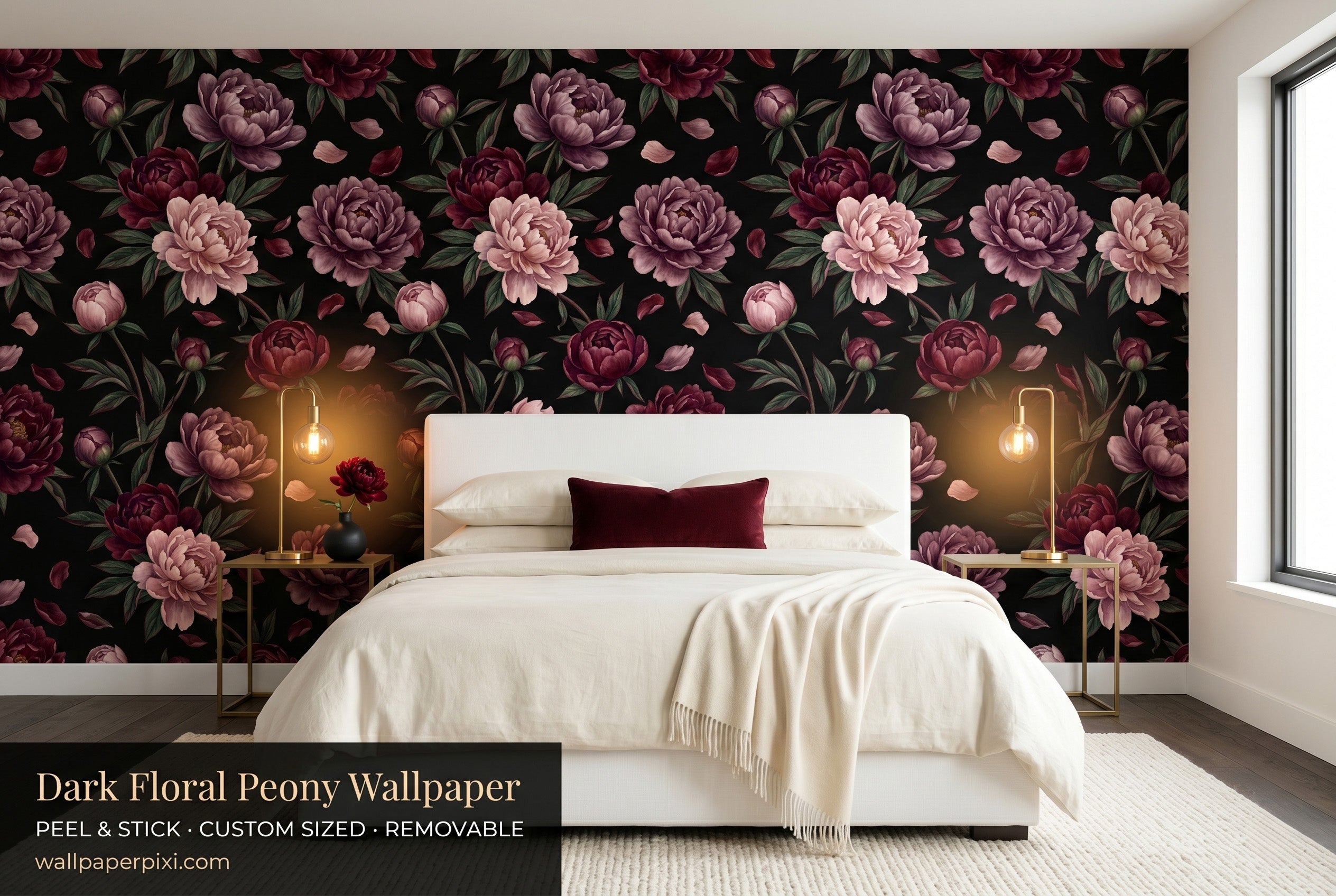 Dark floral black peony wallpaper in a bright dramatic bedroom with a white upholstered bed cream bedding burgundy velvet cushion and warm brass lighting