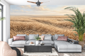 Golden wheat field landscape mural in a warm rustic farmhouse living room