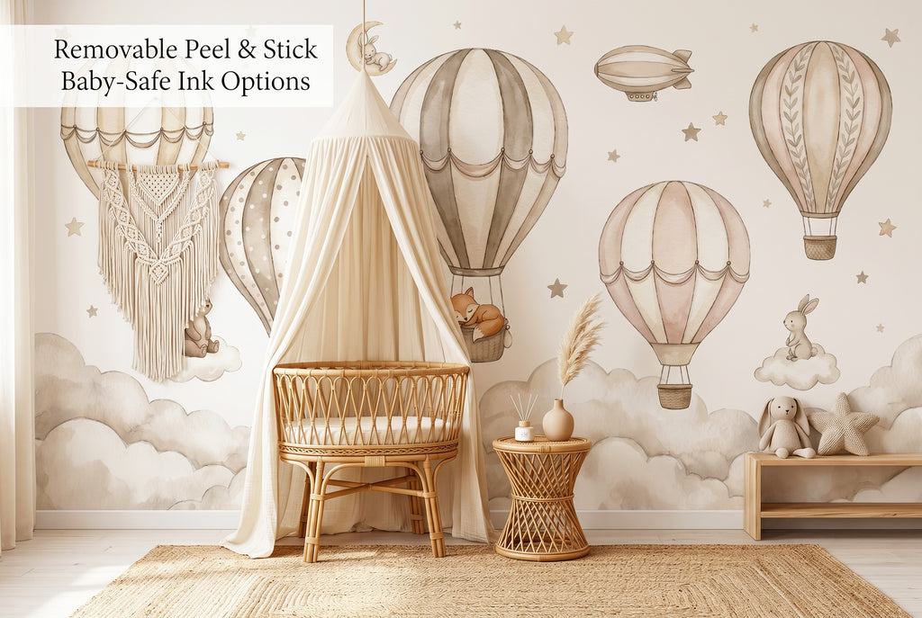 Hot air balloon nursery peel and stick wallpaper mural in a boho nursery with rattan crib and macrame decor