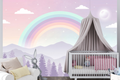 Pastel rainbow forest mural in a dreamy magical baby nursery