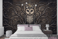 Vintage woodcut owl illustration peel and stick wallpaper behind a dark velvet bed
