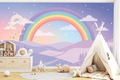 Joyful colorful rainbow wall mural creating a cheerful accent wall in a playroom